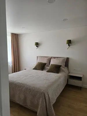 a bedroom with a white bed with two pillows at Central Stay in Šiauliai in Šiauliai