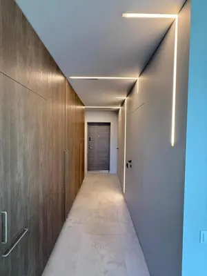 a corridor of a hallway with wooden walls and a door at Moonlight Apartment - Parko rezidencija SELF CHECK IN in Panevėžys