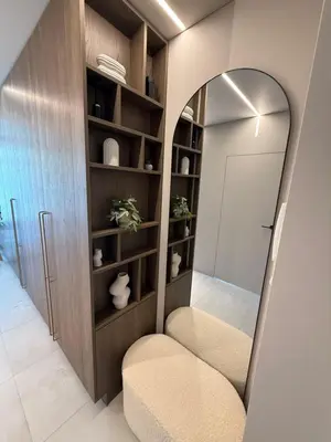 a room with a mirror and a chair and a door at Moonlight Apartment - Parko rezidencija SELF CHECK IN in Panevėžys