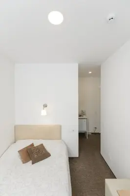 a bedroom with a bed with a book on it at Happy Inn in Kaunas