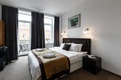 a bedroom with a bed and a large window at Happy Inn in Kaunas