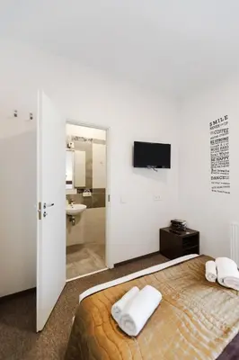a bedroom with a bed with two white towels on it at Happy Inn in Kaunas