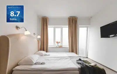 a hotel room with a bed and a window at Happy Inn in Kaunas