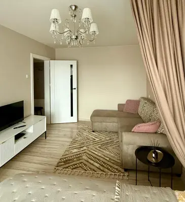 a living room with a couch and a television at Studio apartment Morkus 2 in Šiauliai