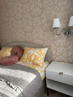 a bedroom with a bed with two pillows and a lamp at Studio apartment Morkus 2 in Šiauliai