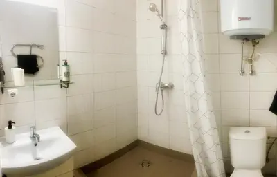 a bathroom with a shower and a toilet and a sink at Studio 10 min walk from old town in Vilnius
