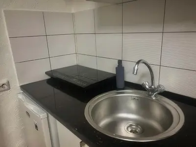 a sink with a soap dispenser on top of it at Studio 10 min walk from old town in Vilnius