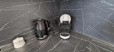 a blender and a hair dryer on a counter at Korsako apartamentai in Šiauliai