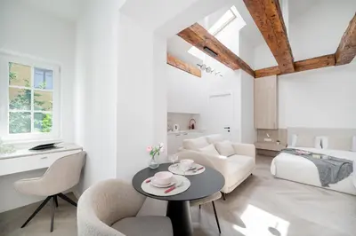 a white living room with a table and chairs at Central Bright I Etmonu st I Easy Check in I Cᴏʜᴏsᴛ in Vilnius