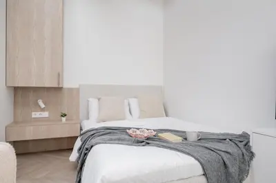 a bedroom with a large white bed with two books on it at Central Bright I Etmonu st I Easy Check in I Cᴏʜᴏsᴛ in Vilnius