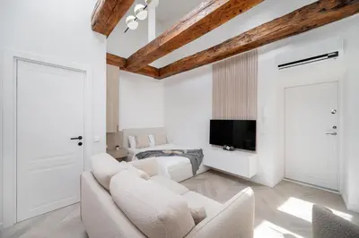 a living room with white furniture and a flat screen tv at Central Bright I Etmonu st I Easy Check in I Cᴏʜᴏsᴛ in Vilnius
