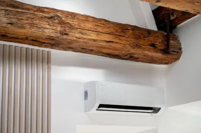 a wooden beam above a microwave on a wall at Central Bright I Etmonu st I Easy Check in I Cᴏʜᴏsᴛ in Vilnius