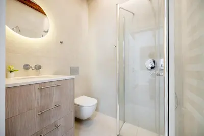 a bathroom with a shower and a toilet and a sink at Central Bright I Etmonu st I Easy Check in I Cᴏʜᴏsᴛ in Vilnius