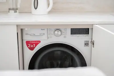 a washing machine under a counter in a kitchen at Central Bright I Etmonu st I Easy Check in I Cᴏʜᴏsᴛ in Vilnius