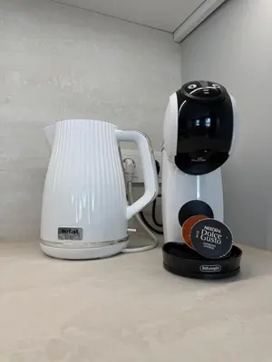 a white and black coffee maker sitting on a counter at Relaxation Corner on Kranto in Kaunas