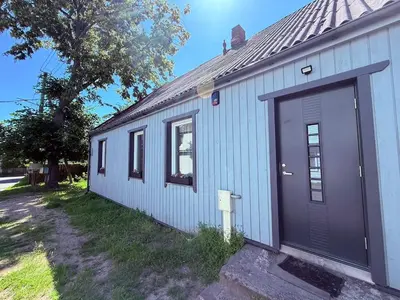 a white house with a large door on the side of it at Relaxation Corner on Kranto in Kaunas