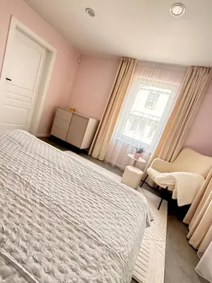 a bedroom with a white bed and a window at Relaxation Corner on Kranto in Kaunas