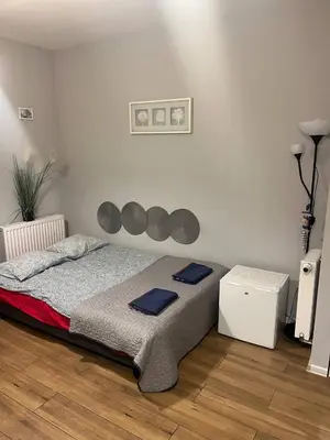 a bedroom with a bed with blue towels on it at Modern flat in Vilnius