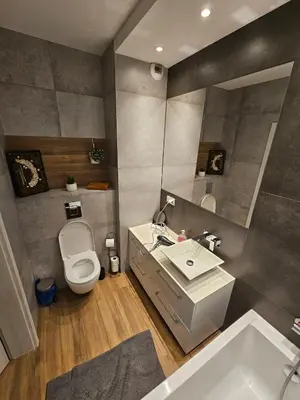 a bathroom with a toilet and a sink and a tub at Modern flat in Vilnius