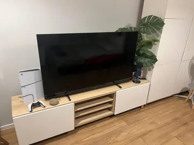 a flat screen tv on a white entertainment center at Modern flat in Vilnius