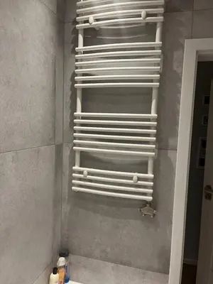 a shower with white towel racks in a bathroom at Modern flat in Vilnius