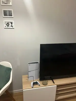 a flat screen tv sitting on top of a table at Modern flat in Vilnius