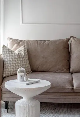 a living room with a couch and a white coffee table at Traku apartament in Pakopi