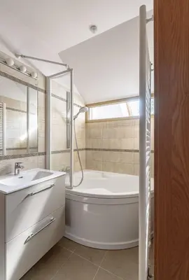 a white bathroom with a tub and a sink at Traku apartament in Pakopi