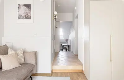 a living room with a couch and a table at Traku apartament in Pakopi