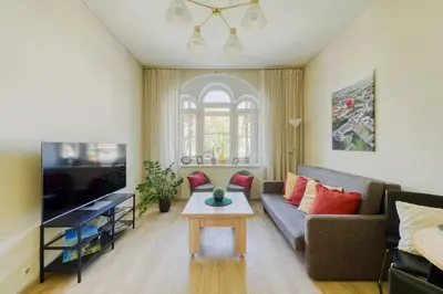 a living room with a couch and a table at Old Town Apartment in Jonava