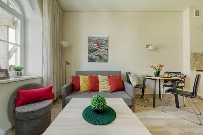 a living room with a couch and a table at Old Town Apartment in Jonava