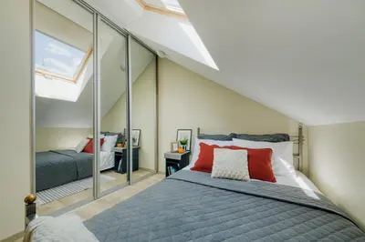 a bedroom with a bed and a large mirror at Old Town Apartment in Jonava