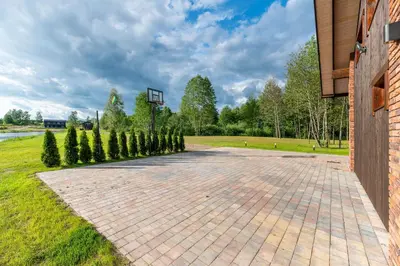 a basketball hoop in a park with trees at Galuonu vilos Ezero in Inturkė