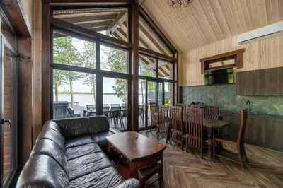 a living room with a couch and a table at Galuonu vilos Ezero in Inturkė