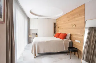 a bedroom with a bed and a wooden wall at Silence of Uzupis - Self Check in in Vilnius