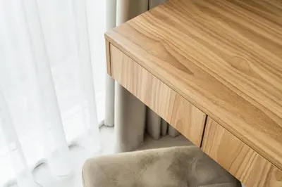 a wooden dresser with a chair next to a window at Silence of Uzupis - Self Check in in Vilnius