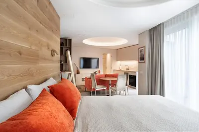 a hotel room with a bed and a living room at Silence of Uzupis - Self Check in in Vilnius