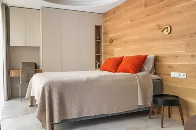 a bedroom with a bed with orange pillows on it at Silence of Uzupis - Self Check in in Vilnius