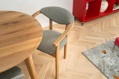 a wooden table with a chair next to a table at Ducks in the yard - Self Check in in Vilnius