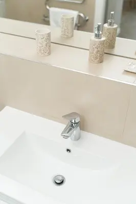 a bathroom sink with three cups on the counter at Ducks in the yard - Self Check in in Vilnius