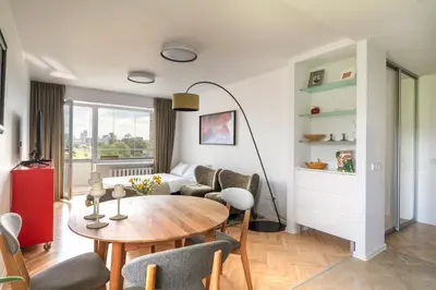 a living room with a table and a couch at Ducks in the yard - Self Check in in Vilnius