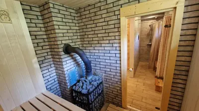 a brick wall with a trash can in a hallway at Viensėdis in Anykščiai