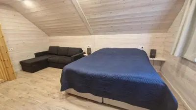 a bedroom with a bed and a couch at Viensėdis in Anykščiai