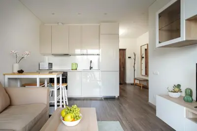 a kitchen and living room with a couch and a table at Skansen Vilnius City Center in Vilnius