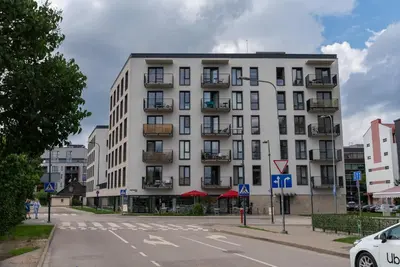 a white building on the corner of a street at Skansen Vilnius City Center in Vilnius