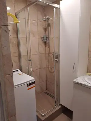 a shower with a glass door in a bathroom at Prie Agluonos in Biržai