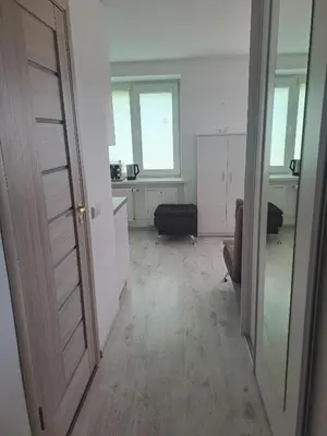 an open door to a room with a living room at Prie Agluonos in Biržai