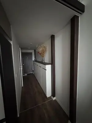 an empty hallway with a plant in a vase on a counter at Locusdo Apartment Nr 32 in Vilnius