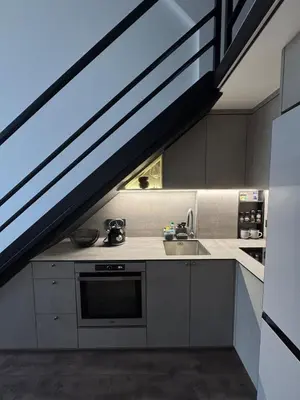 a kitchen with a sink and a staircase in a room at Locusdo Apartment Nr 32 in Vilnius