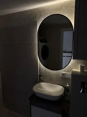 a bathroom with a white sink and a mirror at Locusdo Apartment Nr 32 in Vilnius